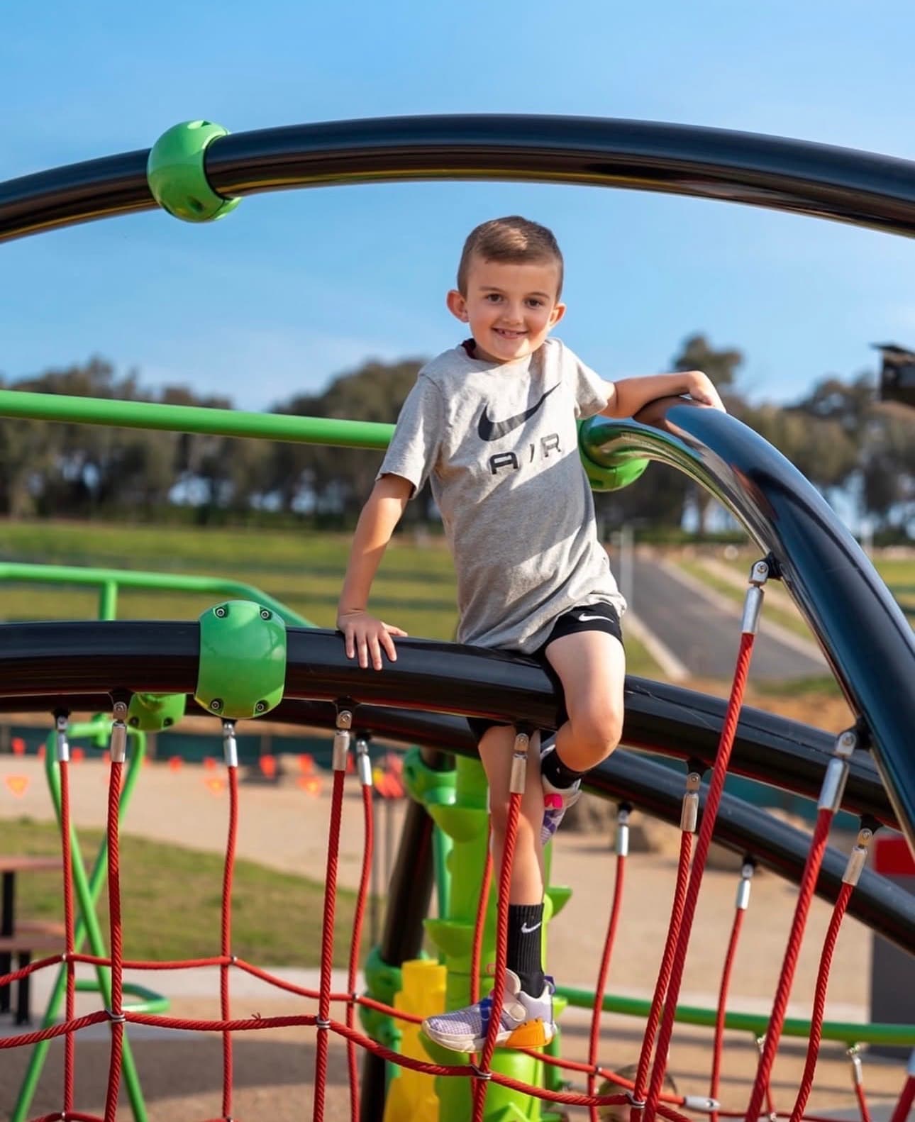A child playing on a Kidzspace rope climber