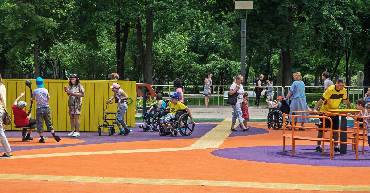 people of all abilities happily utilising an inclusive playground