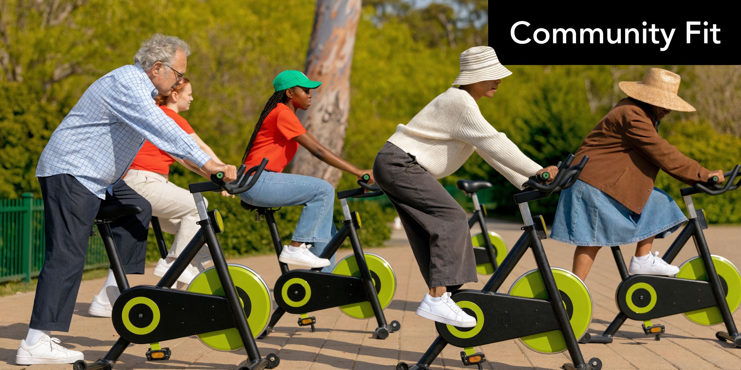 A diverse group of people exercising on stationary bikes outdoors in a park for community health.