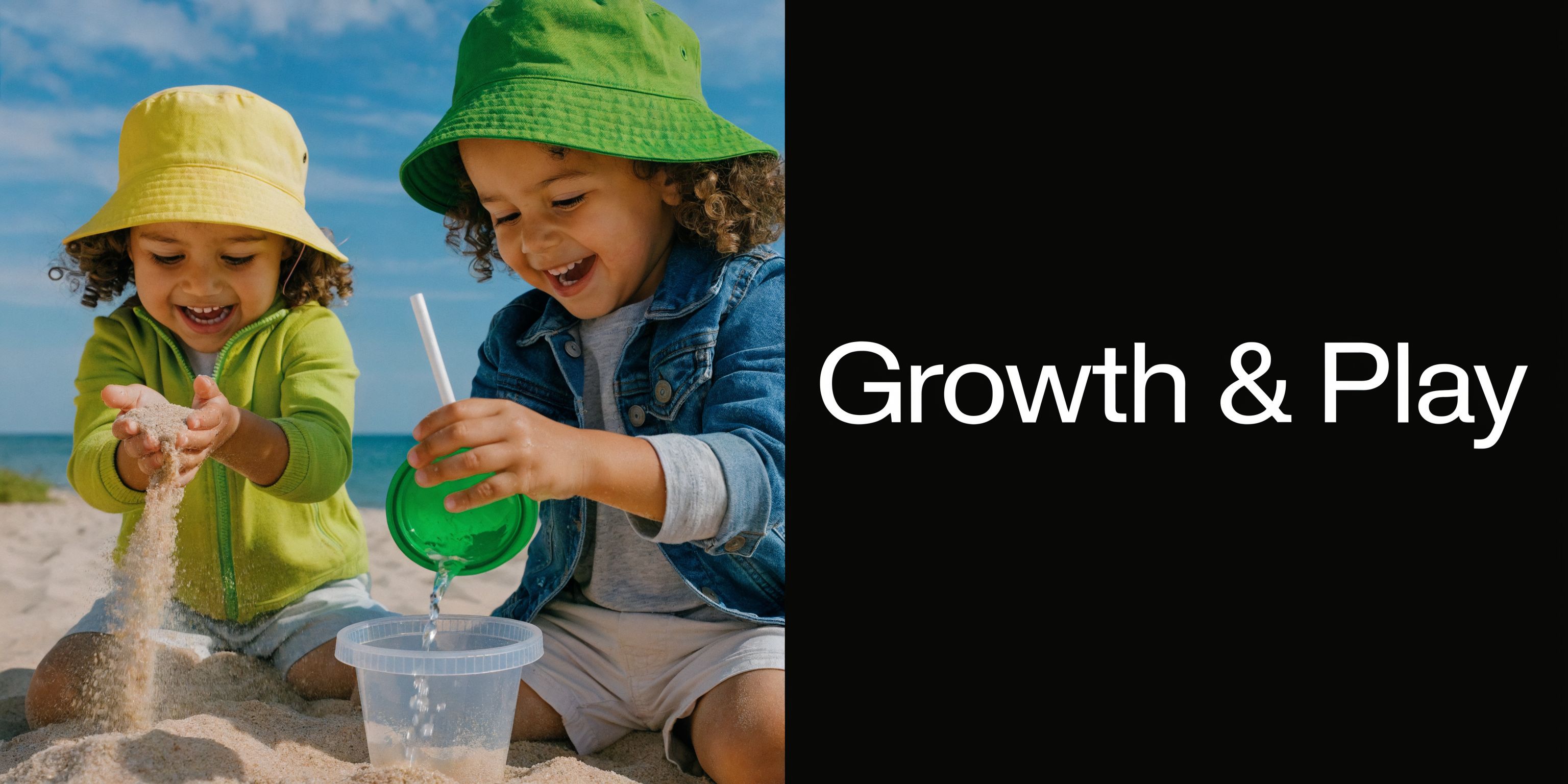 Two young children wearing colorful bucket hats play together with sand and water on a sunny beach.