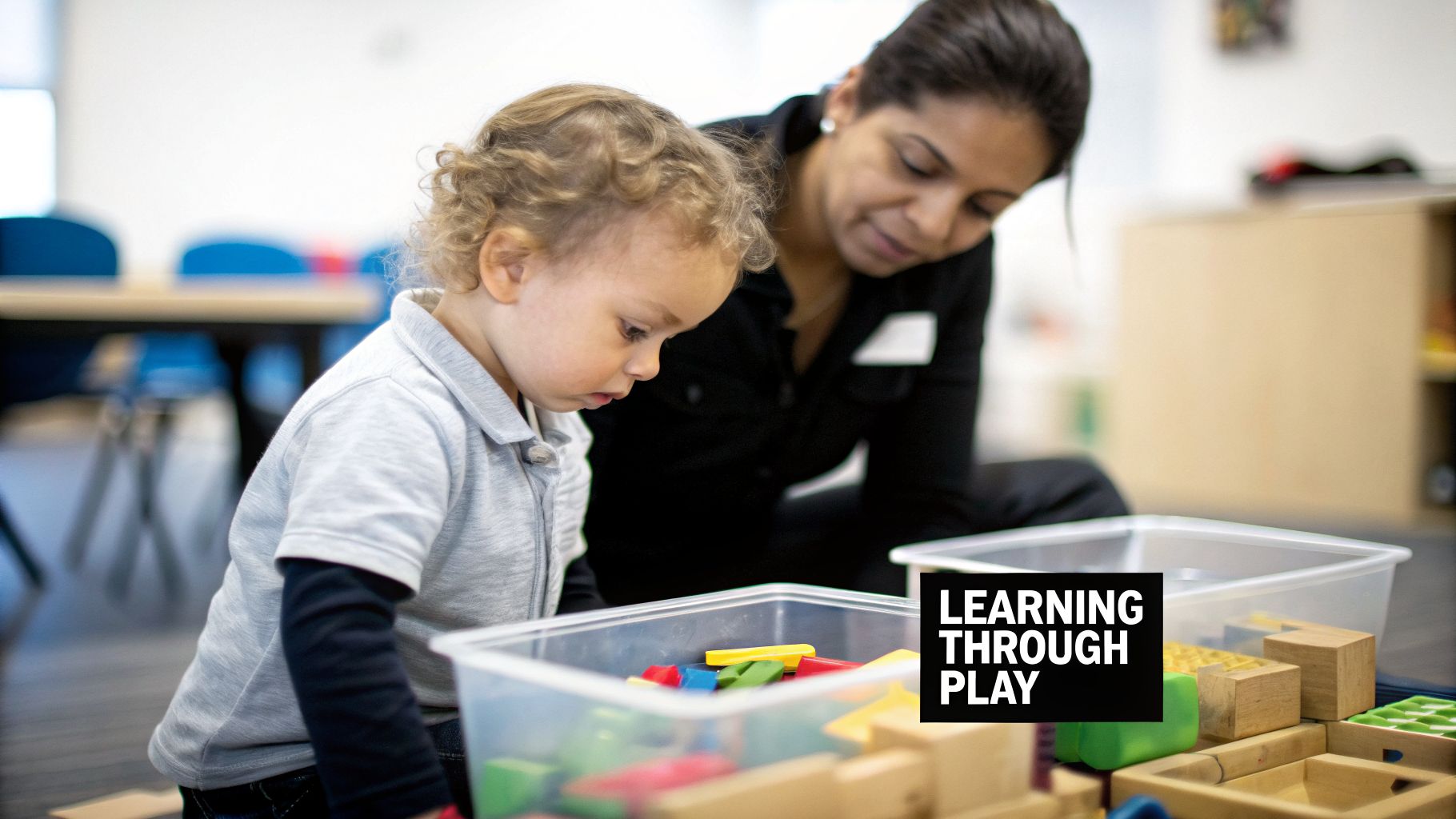 A young child engages in play-based learning with colorful building blocks, supervised by an adult.